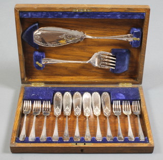 An oak canteen containing plated fish servers and eaters for 6