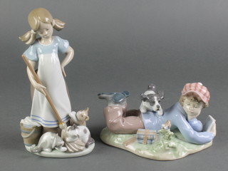 2 Lladro figures of a young boy reclining with a dog 5451 7" and a young girl with a broom and kittens at her feet 8" 
