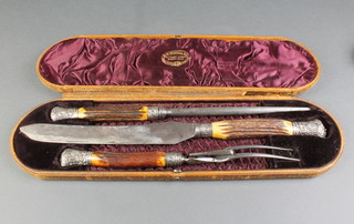 A Victorian cased 3 piece carving set with horn handles and repousse mounts 