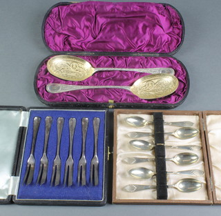 A pair of silver plated cased gilt berry spoons, 2 cased sets 