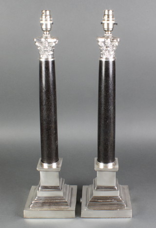 A pair of plated mounted black marble Corinthian column table lamps on stepped bases 23"h