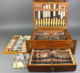An Edwardian oak canteen with locking bars, lift top and drawer containing a part canteen of silver plated cutlery for 6, minor cutlery 
