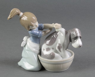 A Lladro figure of a young girl washing a hound in a barrel 5455 4" 