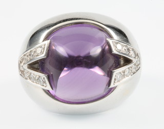 Versace, an 18ct white gold amethyst and diamond ring, the cabuchon centre stone flanked by 7 diamonds in the shape of a V,signed Versace, size M 