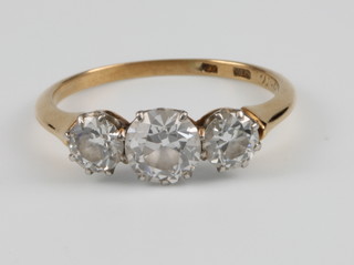 An 18ct yellow gold 3 stone diamond ring, the centre brilliant cut stone approx 0.7ct flanked by a by a brilliant cut stone approx 0.33ct each, size M 