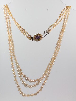 A 3 strand necklace of graduated cultured pearls with a 9ct gold amethyst and pearl set clasp 20" 