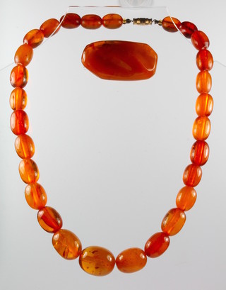 A string of amberoid beads 17" together with a ditto brooch 