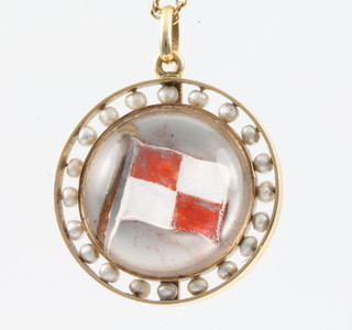 An Edwardian gold and seed pearl mounted reverse intaglio pendant in the form of a flag signal "Uniform coming into danger" surrounded by 20 seed pearls on a 14ct yellow gold chain 