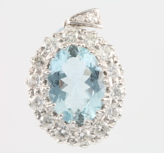 An 18ct white gold aquamarine and diamond pendant, the centre stone approx 5ct, surrounded by 14 brilliant cut diamonds approx. 1.5ct, on a diamond set loop