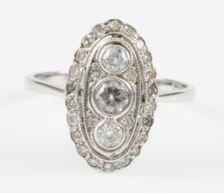 An Edwardian style up finger diamond ring with 3 centre brilliants surrounded by smaller brilliants, approx. 0.70ct, size N 