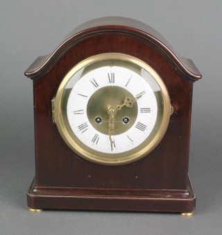 A 19th Century French 8 day striking mantel clock with enamelled dial, Roman numerals, contained in an arched mahogany case 