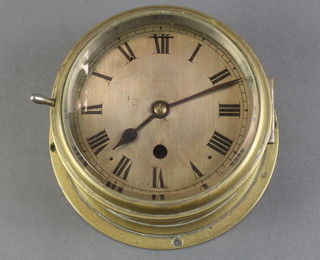 A ward room style clock with 5" silvered dial and Roman numerals, contained in a brass case 