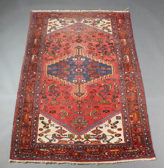 A Persian Brojered red and blue ground rug with stylised diamond to the centre 79" x 61" 