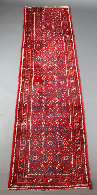 A Persian Nahavand red and floral patterned runner 121" x 32"