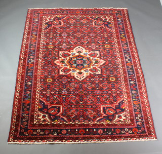 A Persian Hamedan red and blue ground rug with central medallion 80" x 60"