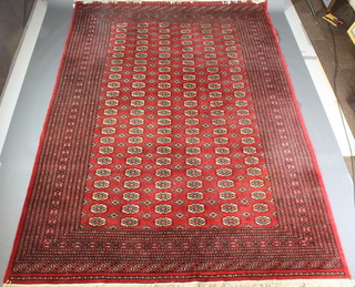A red ground Bokhara carpet with 138 octagons to the centre 122" x 87" 