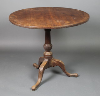 A Georgian circular mahogany snap top tea table raised on turned column and tripod supports with shell carving to the knees 27"h x 32" diam. 