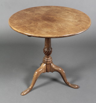 A Georgian circular mahogany snap top tea table, raised on turned column and tripod base 28"h x 28" diam. 