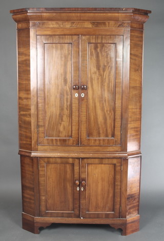 A 19th Century mahogany corner cabinet with moulded cornice, fitted cupboards enclosed by panelled doors, raised on bracket feet 68"h x 41"w x 22 1/2"d 