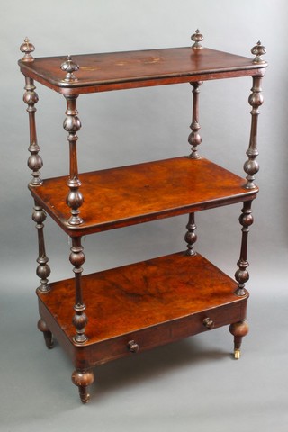 A Victorian rectangular figured walnut 3 tier what-not, raised on turned and fluted supports, the base fitted an under tier, raised on bun feet with ceramic casters, 40"h x 25 1/2"w x 15 1/2"d 