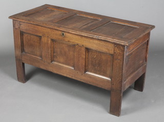 A 17th/18th Century oak coffer of panelled construction with hinged lid, the interior fitted a candle box 26"h x 46"w x 21"d 