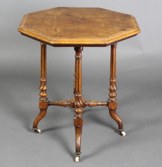 A Victorian octagonal figured walnut occasional table, raised on turned and fluted supports with X framed stretcher and ceramic casters 24"h x 22 1/2"w x 22 1/2"d 