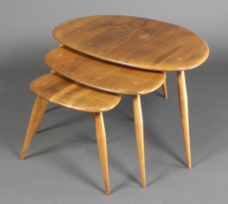 Ercol, a nest of 3 light elm "Pebble" interfitting coffee tables, raised on turned supports, largest  15"h x 25" x 17"d, middle 14"h x 19"w x 13"d, smallest 12"h x 13"w x 9 1/2"d  