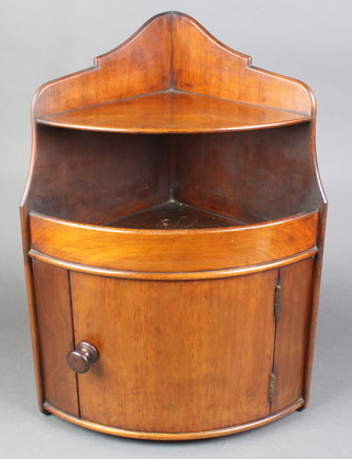 A Victorian mahogany bowfront hanging corner cabinet with recess above cupboard 20 1/2"h x 13"w x 9"d 