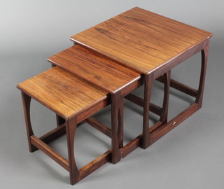 A nest of 3 Danish rosewood interfitting coffee tables, largest 18"h x 19 1/2"w x 19 1/2"d, middle 16 1/2"h x 16 1/2"w x 16 1/2"d, smallest 15 1/2"h x 13 1/2"w x 13 1/2"d