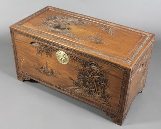 A Chinese carved camphor coffer with hinged lid, the interior fitted a tray carved landscape and bamboo decoration, raised on bracket feet 21"h x 41"w x 20 1/2"d 