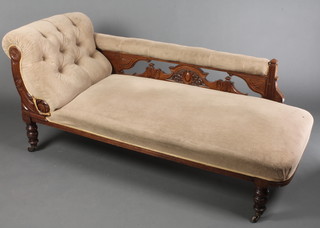 A Victorian mahogany carved walnut show frame left arm chaise longue upholstered in brown material, raised on turned supports 