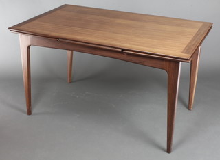 In the manner of Younger, a mid 20th Century rectangular teak draw leaf dining table on square tapering supports 29"h x 51"l x  x 83" when fully extended x 32"w 