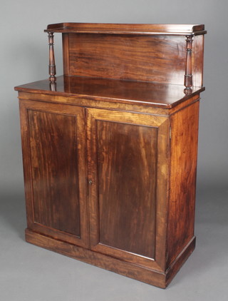 A Victorian mahogany chiffonier the raised back fitted a shelf, the interior fitted shelves enclosed by panelled cupboards, raised on a platform base 50 1/2"h x 37"w x 19"d 