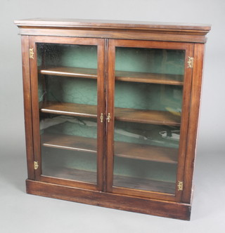 A Victorian mahogany display cabinet, interior fitted shelves enclosed by glazed panelled doors and raised on a platform base 43"h x 42"w x 12"d
