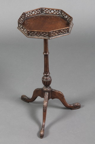 A Georgian style octagonal wine table with pierced gallery, raised on a turned and fluted column with tripod base 24"h x 10"w x 10"d 