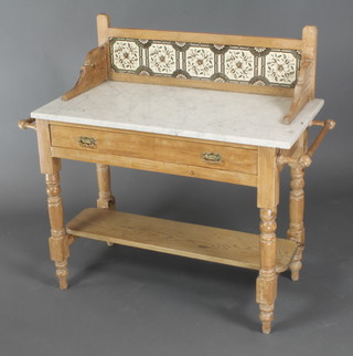 A Victorian pine wash stand with raised tiled back and white veined marble top, the base fitted 1 long drawer with turned towel rails to the side and under tier, raised on turned supports 38"h x 26"w x 18 1/2"d