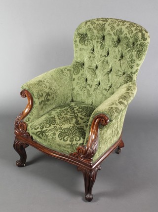 A Victorian carved rosewood show frame armchair raised on cabriole supports upholstered in buttoned back sculpted material 