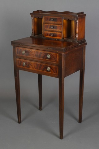 A Victorian style inlaid mahogany lady's writing table, the raised superstructure to the back with three-quarter gallery fitted 2 niches and 3 drawers, the base fitted 2 long drawers, raised on square tapered supports 39"h x 20"w x 14 1/2"d 