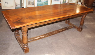 An "elm" refectory table, the top formed of 3 planks raised on turned and block supports with H framed stretcher 29"h x 94 1/2"l x 33 1/2"w