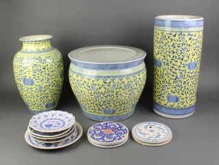 A 20th Century Chinese yellow and blue ground fish bowl 14", a similar vase 14", a cylindrical stick stand 17" and a collection of tea plates and coasters 
 