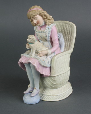 A 19th Century Continental bisque figure of a young girl sitting in a chair with a dog on her lap 8 1/4" 