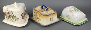 A rectangular Carlton Ware cheese dish and cover (chip to base), a green glazed rectangular cheese and cover with floral decoration and a wedge shaped cheese dish and cover (chipped) 