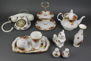 A 59 piece Royal Albert Old Country Rose pattern tea/dinner service comprising 6 dinner plates, twin handled tureen, teapot, cream jug, sugar bowl, sauce boat and stand, 2 pepper pots, 8 tea cups and 8 saucers (4 are seconds), bread and butter plate, 9 plates, 6 tea plates, 6 saucers, sandwich plate (second), small teapot, cream jug, sugar bowl, small cup and saucer, saucer, cake stand, tea for one saucer, 2 vases, Happy Birthday dish, mug (second), figure of a seated squirrel, telephone, gilt cake slice, small dish 