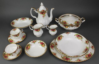 A 92 piece Royal Albert Old Country Rose pattern dinner/tea service comprising 8 dinner plates (2 seconds), 8 side plates (2 seconds), 12 tea plates, 2 circular twin handled tureens and covers, oval meat plate, circular bowl, oval bowl (second), sauceboat and stand, 2 cereal bowls (seconds), bowl with scalloped edge (second), 6 small bowls, coffee pot, cream jug, rectangular sandwich plate, twin handled bread plate (cracked), small sugar bowl and cream jug, 8 coffee cans (2 seconds), 6 coffee saucers, sugar bowl, 6 twin handled soup bowls and saucers, 9 tea cups (3 seconds), 6 tea saucers 