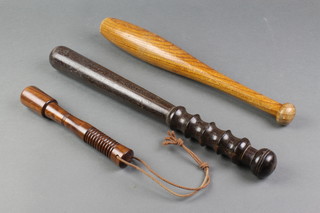 A turned wooden truncheon together with 2 turned wooden priests 