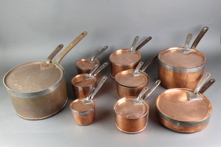 A set of 19th Century graduated copper saucepans with steel handles and associated lids  11", 2 x 9", 7", 2 x 6", 2 x 5", 4", together with a ditto frying pan 9" 