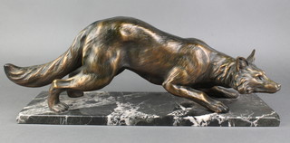 An Art Deco style bronzed resin figure of a walking fox raised on a rectangular marble base 