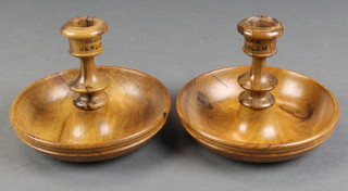 A pair of circular turned olive wood campaign style candlesticks 5" 