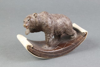 A Swiss carved wooden desk blotter in the form of a bear 5"  