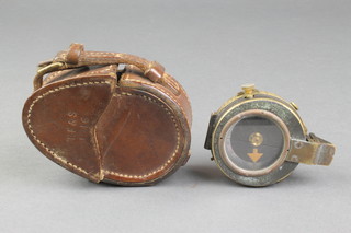 A First World War Military issue prismatic compass contained in a leather carrying case marked TF & S  